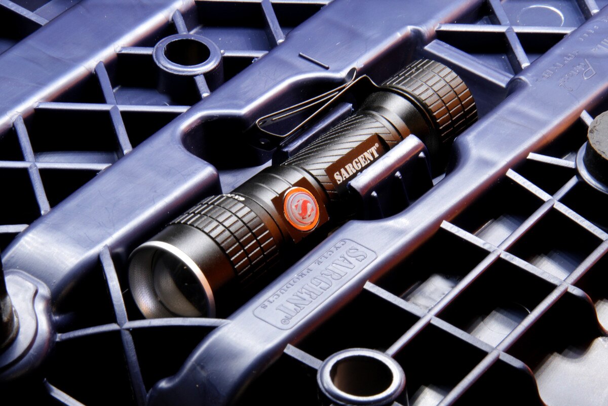 Built-in, high-intensity, rechargeable LED flashlight in the rear aftermarket motorcycle seat from Sargent, shown with Performance Plus Regular Height Front All Black.